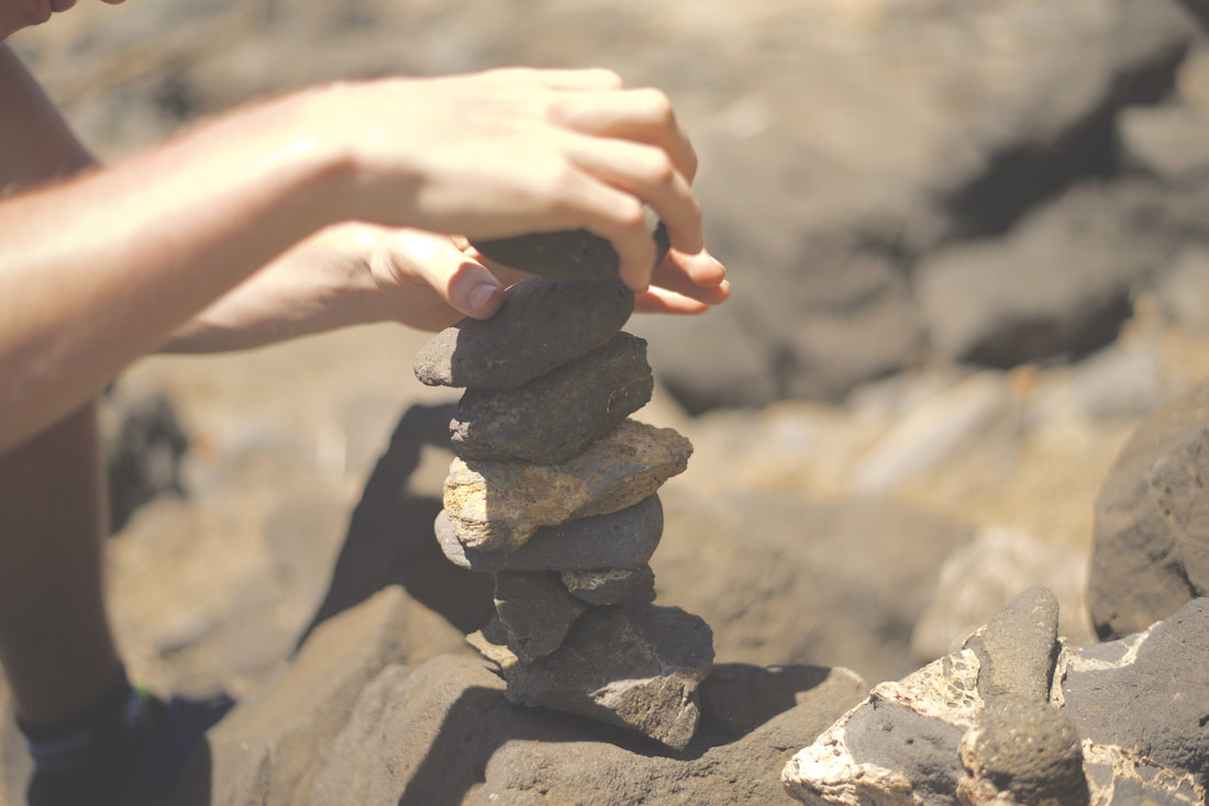 Picture of person stacking rocks
